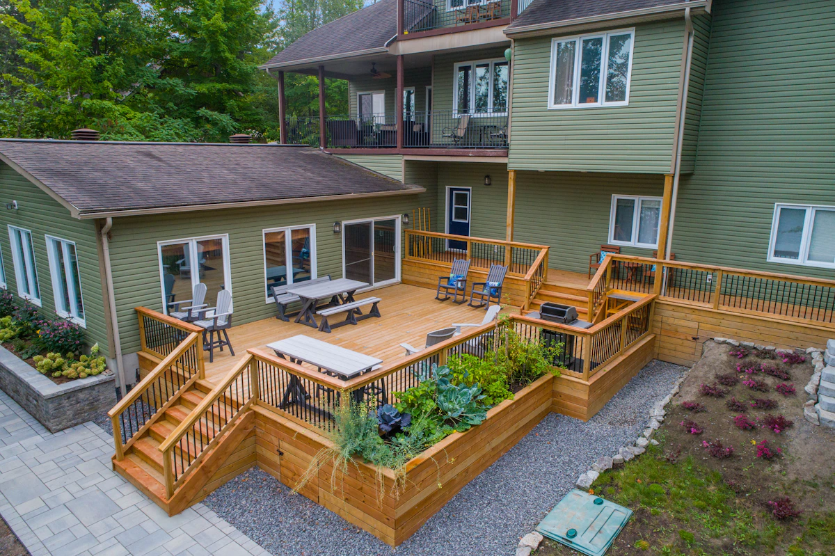 Large backyard deck freshly stained in a rich brown tone